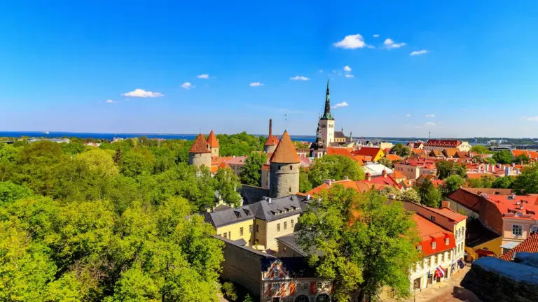 Panoraamvaade Tallinna vanalinnale koos ajalooliste tornide ja punaste katustega päikeselisel päeval.